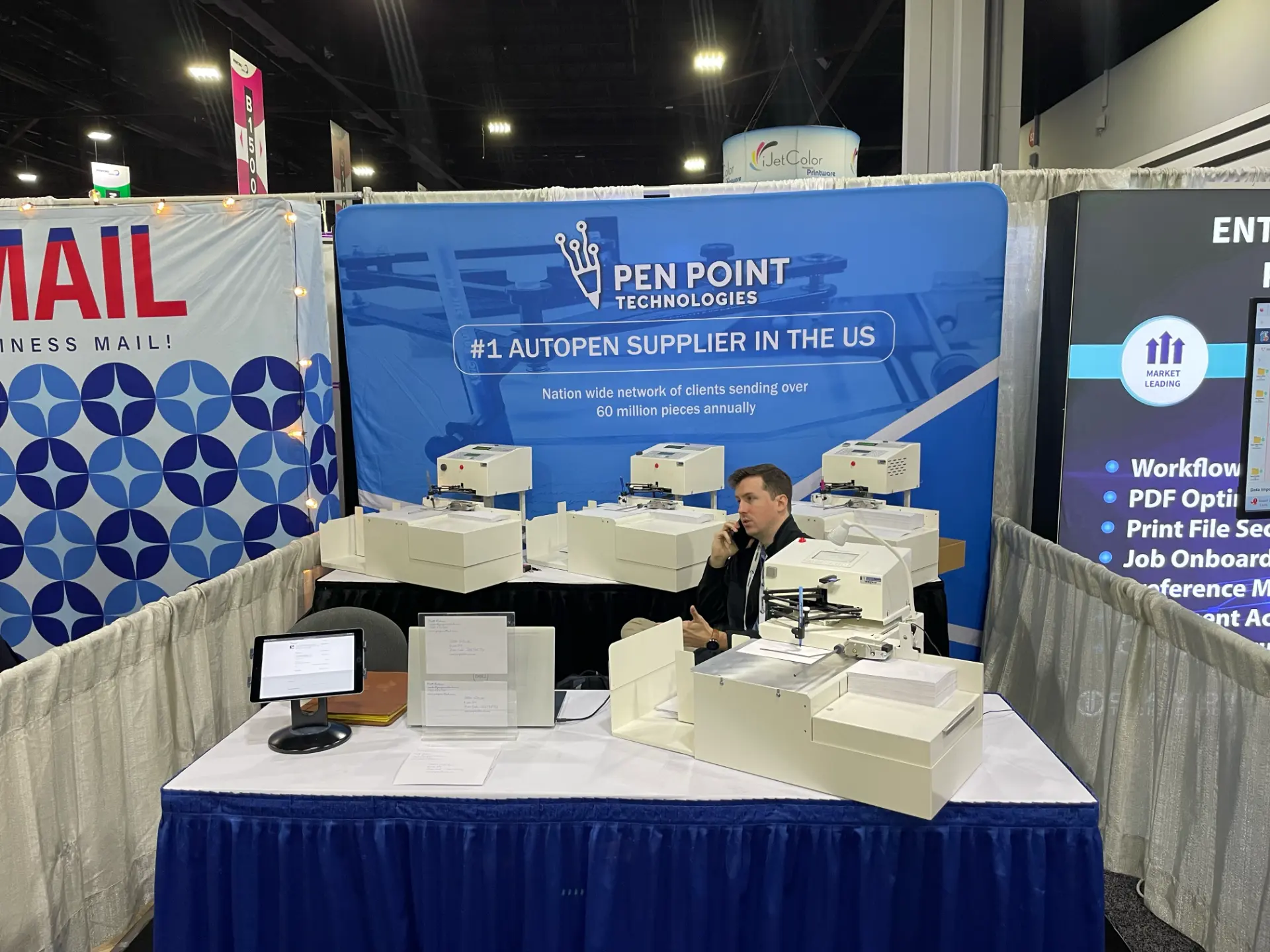 Pen Point Technologies trade-show booth with multiple UniProd handwriting machines on display